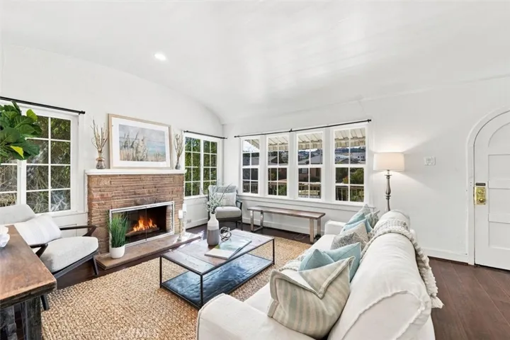 Living room w/ fireplace. Fire in fireplace is virtually enhanced, BTV.
