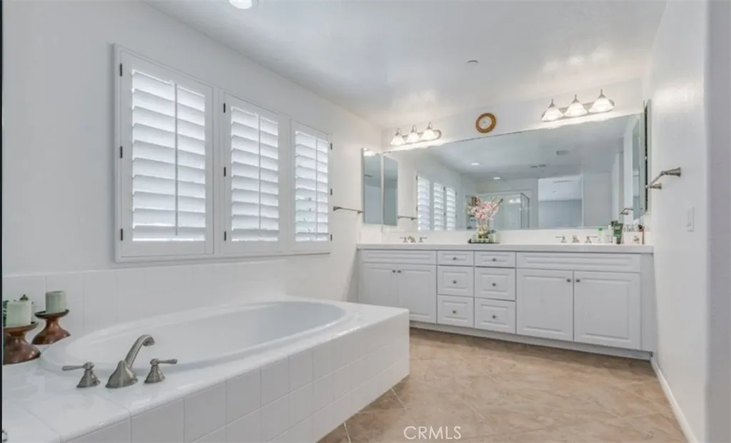 Primary bathroom with soaking tub and dual vanity. Also seperate shower, private toilet room and through this room a walk in closet Primary bathroom with soaking tub and dual vanity. Also seperate shower, private toilet room and through this room a walk in closet