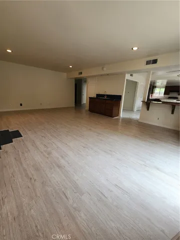 Family room with wet bar and looking into kitchen area