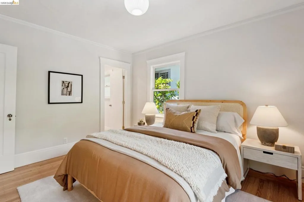 Wood-finish flooring, white walls, white trim, and a white ceiling Wood-finish flooring, white walls, white trim, and a white ceiling