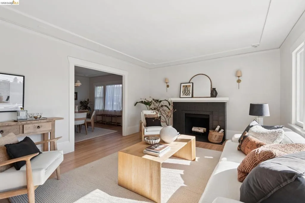 Fireplace featuring a dark tile surround and white mantel Fireplace featuring a dark tile surround and white mantel