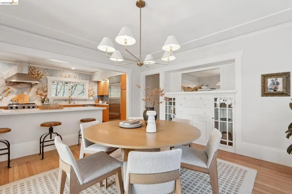 Hardwood flooring, kitchen with stainless steel appliances, built-in cabinetry, recessed lighting, and a contemporary chandelier Hardwood flooring, kitchen with stainless steel appliances, built-in cabinetry, recessed lighting, and a contemporary chandelier