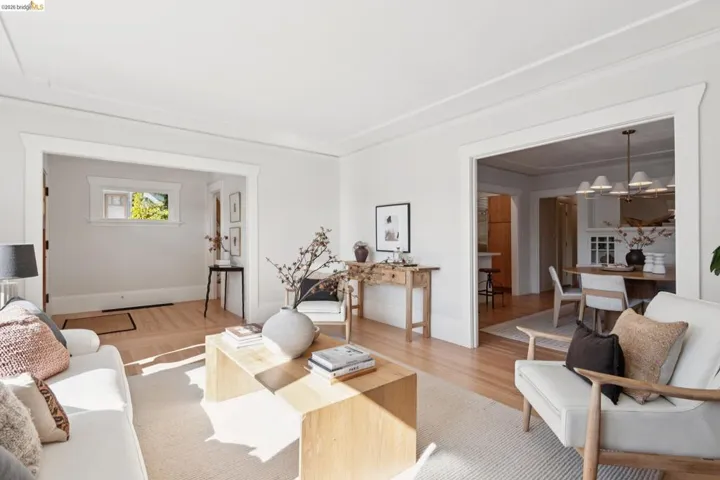Light wood-finish flooring, white walls, and a recessed ceiling panel create a bright interior