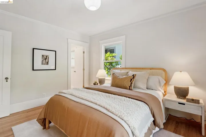 Wood-finish flooring, white walls, white trim, and a white ceiling
