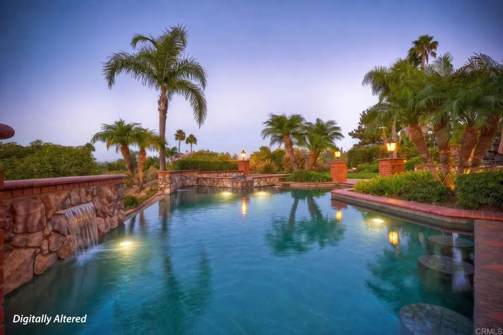 Amazing pool with water features, pool lighting & 4 built in bar stools next to outdoor kitchen. Amazing pool with water features, pool lighting & 4 built in bar stools next to outdoor kitchen.