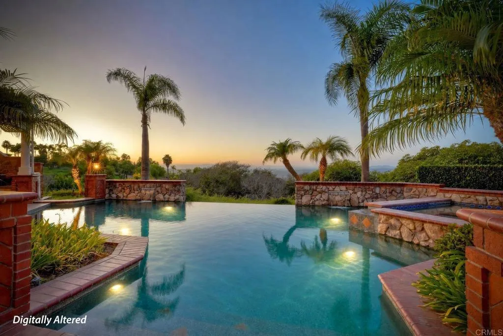 Amazing pool with water features, pool lighting & 4 built in bar stools next to outdoor kitchen. Amazing pool with water features, pool lighting & 4 built in bar stools next to outdoor kitchen.