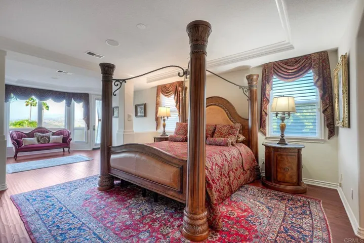 Primary bedroom ensuite with sitting area, cozy fireplace & private balcony