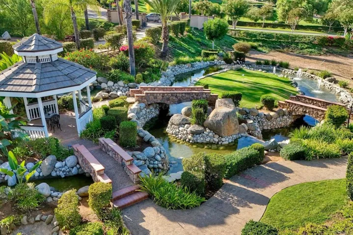 Amazing pond and water feature with multiple waterfalls, bridges & putting green for golf fun!
