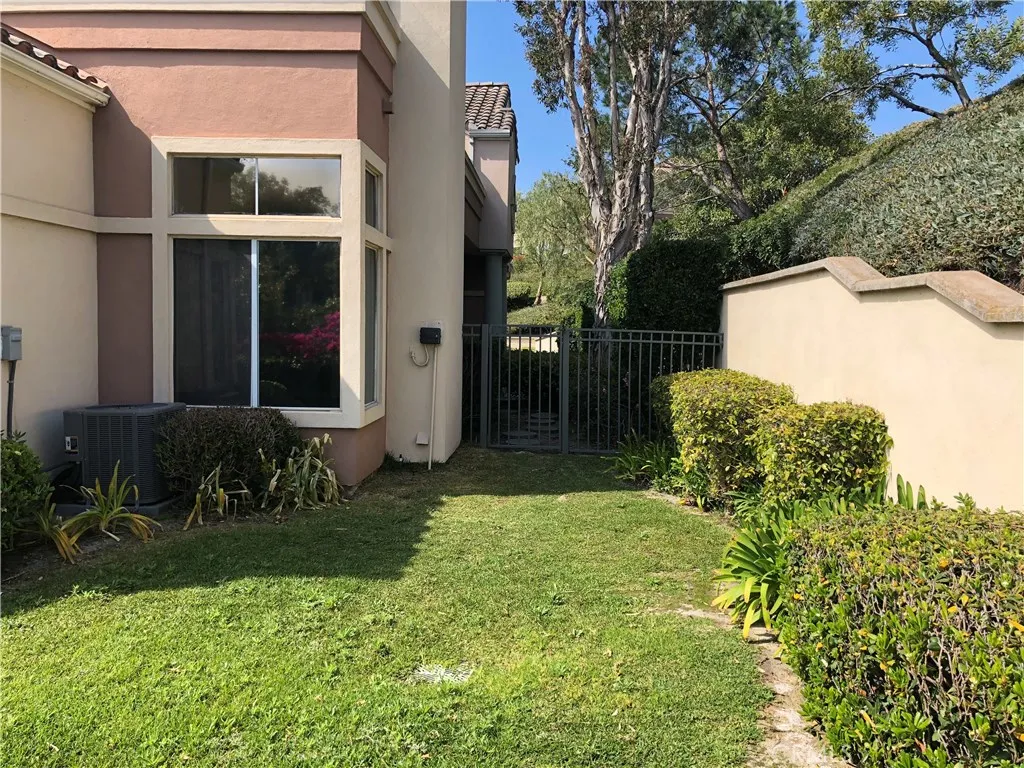 End unit with side yard and gated entry