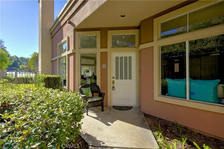 HOA maintained landscape frames the walk way to the front door.