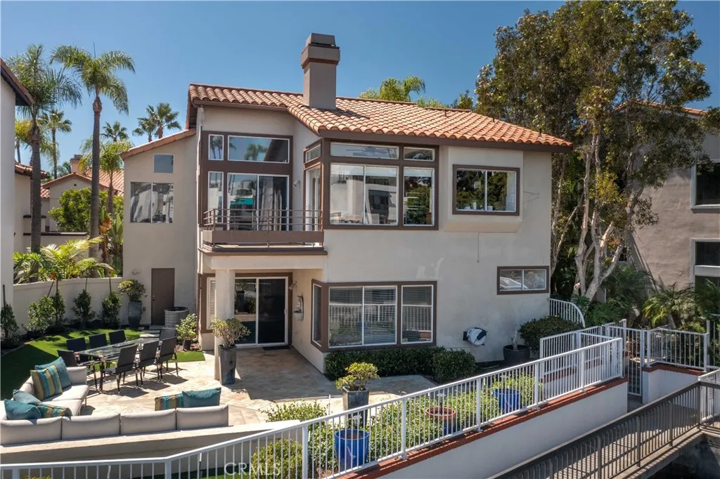Newly renovated rear yard has brand new artificial turf and plantings as well as a spacious hardscaped patio elevated from the walkways for even better views