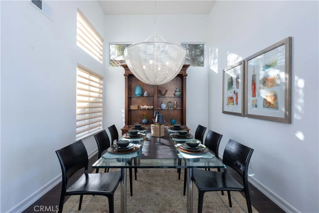 An ample formal dining area boasts a beautiful and textural newer chandelier