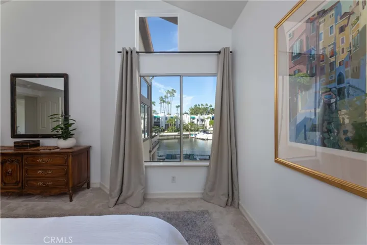 Large, clear windows make the water views visible from the primary bed as currently situated