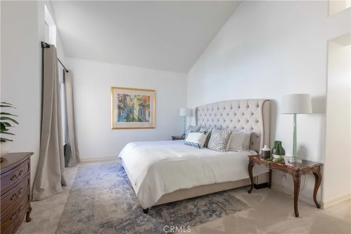 A generously sized primary bedroom is located on the top level with vaulted ceilings