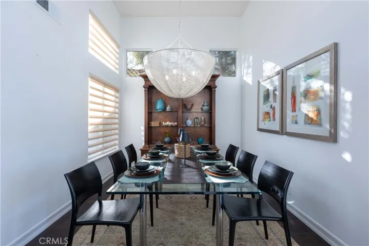 An ample formal dining area boasts a beautiful and textural newer chandelier