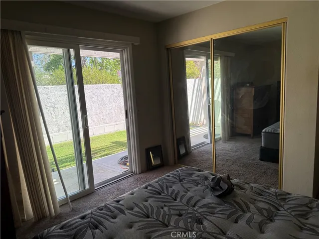 Second bedroom with sliding door to backyard.