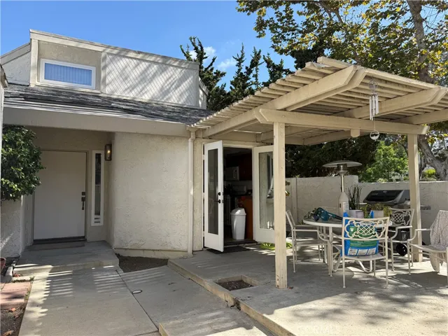Front of the home with patio facing entrance.