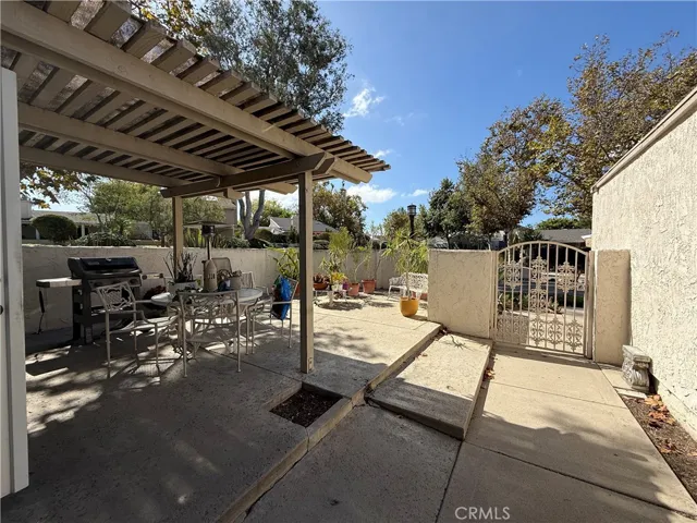 Beautiful, sunlit patio with a gated entrance.