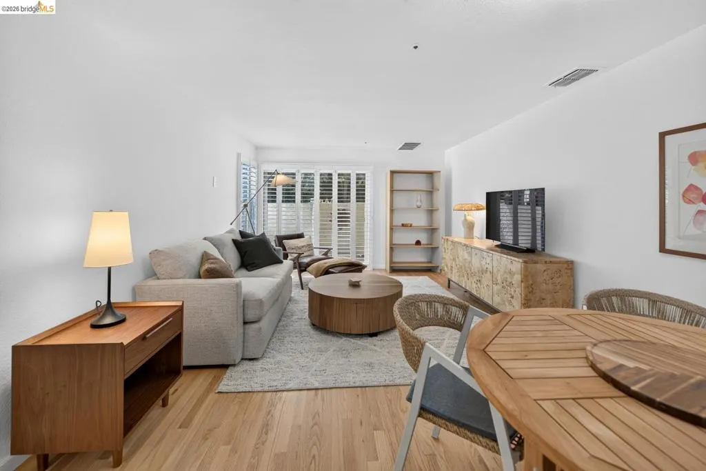 Light wood-finish flooring throughout, white walls, and built-in shelving Light wood-finish flooring throughout, white walls, and built-in shelving