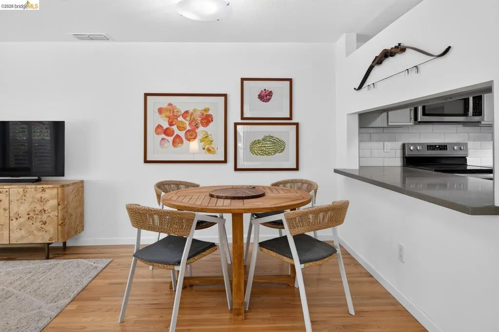 Hardwood flooring throughout, with a built-in kitchen pass-through and a countertop bar Hardwood flooring throughout, with a built-in kitchen pass-through and a countertop bar