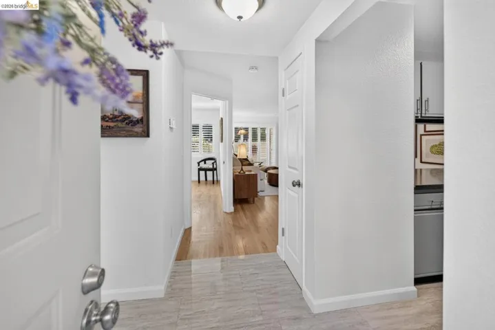 Entrance with light-toned tile flooring and white trim