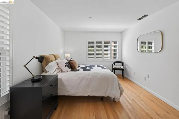Hardwood flooring, plantation shutters, recessed lighting, and a neutral color palette