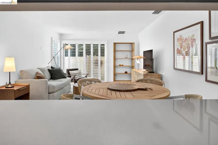 Recessed lighting, wood-finish flooring, white walls, and a built-in shelving unit