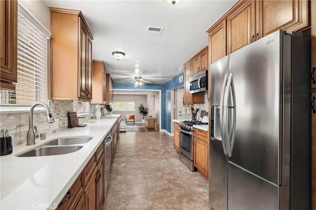 Generously sized kitchen featuring abundant wood cabinetry, extensive counter space, stainless steel appliances and plenty of room for meal preparation and storage. Generously sized kitchen featuring abundant wood cabinetry, extensive counter space, stainless steel appliances and plenty of room for meal preparation and storage.