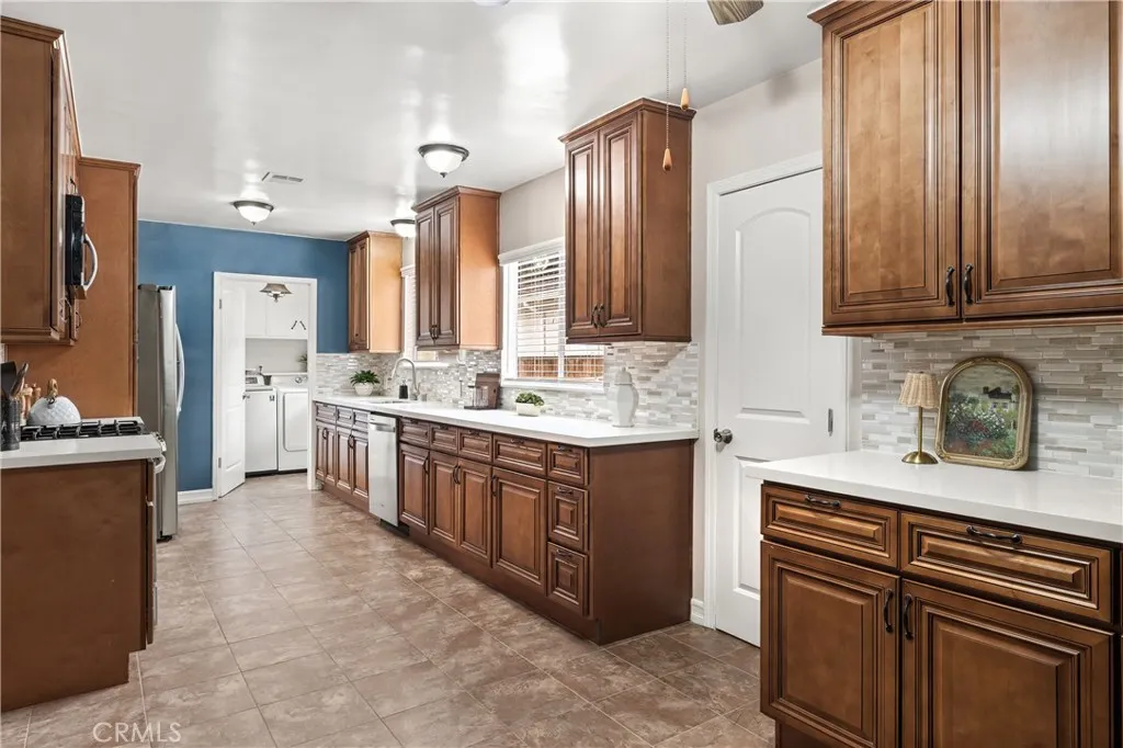 Large kitchen with extensive cabinetry, stainless steel appliances and generous countertop space for cooking and entertaining. Large kitchen with extensive cabinetry, stainless steel appliances and generous countertop space for cooking and entertaining.