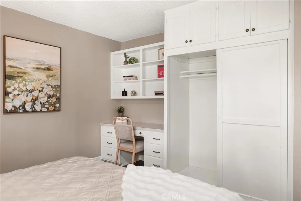Built-in desk, shelving and storage create a convenient workspace within the 2nd Primary bedroom—ideal for working or studying from home. Built-in desk, shelving and storage create a convenient workspace within the 2nd Primary bedroom—ideal for working or studying from home.