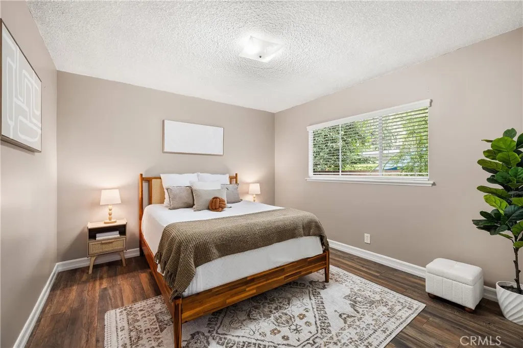 Spacious 4th bedroom features warm wood-style flooring, abundant natural light and room for a comfortable seating area. Spacious 4th bedroom features warm wood-style flooring, abundant natural light and room for a comfortable seating area.