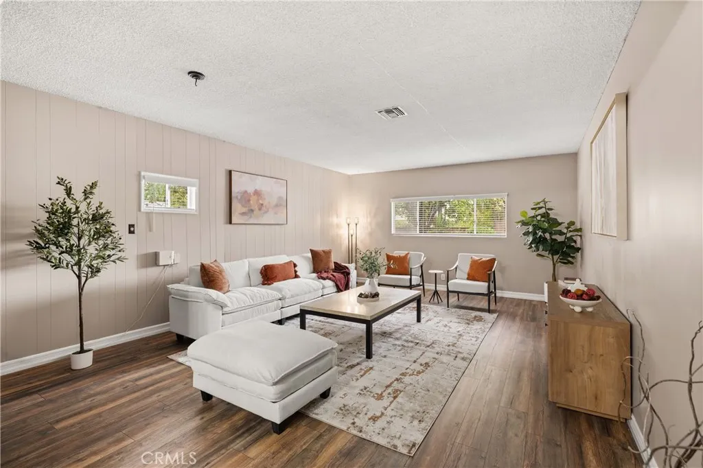 Bright, spacious family room showcases the home’s generous proportions, wood-style flooring and flexible open layout. Bright, spacious family room showcases the home’s generous proportions, wood-style flooring and flexible open layout.