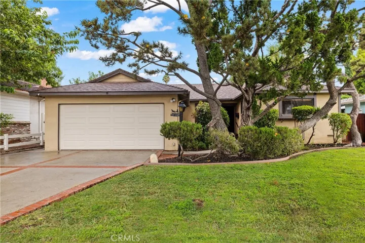 Charming North Hills home with an attached garage, mature landscaping and an inviting residential setting.
