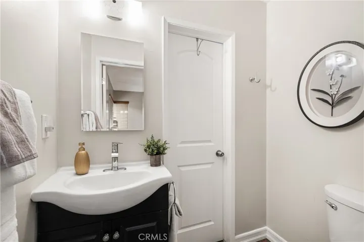 Convenient attached 2nd primary bathroom with vanity and neutral finishes.
