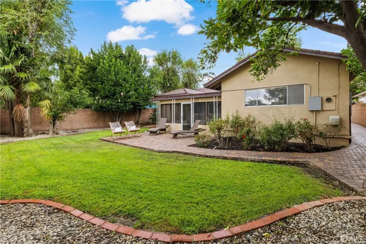 Large grassy backyard offers mature trees, established landscaping and generous outdoor space for relaxing, entertaining and recreation.