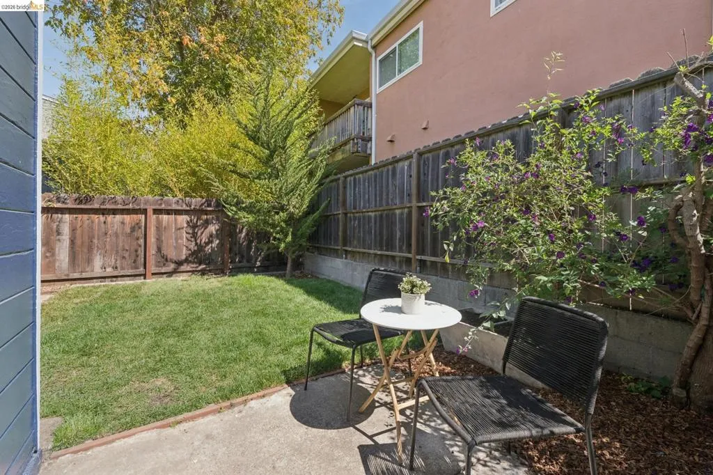 Private patio with concrete paving and perimeter wood fencing