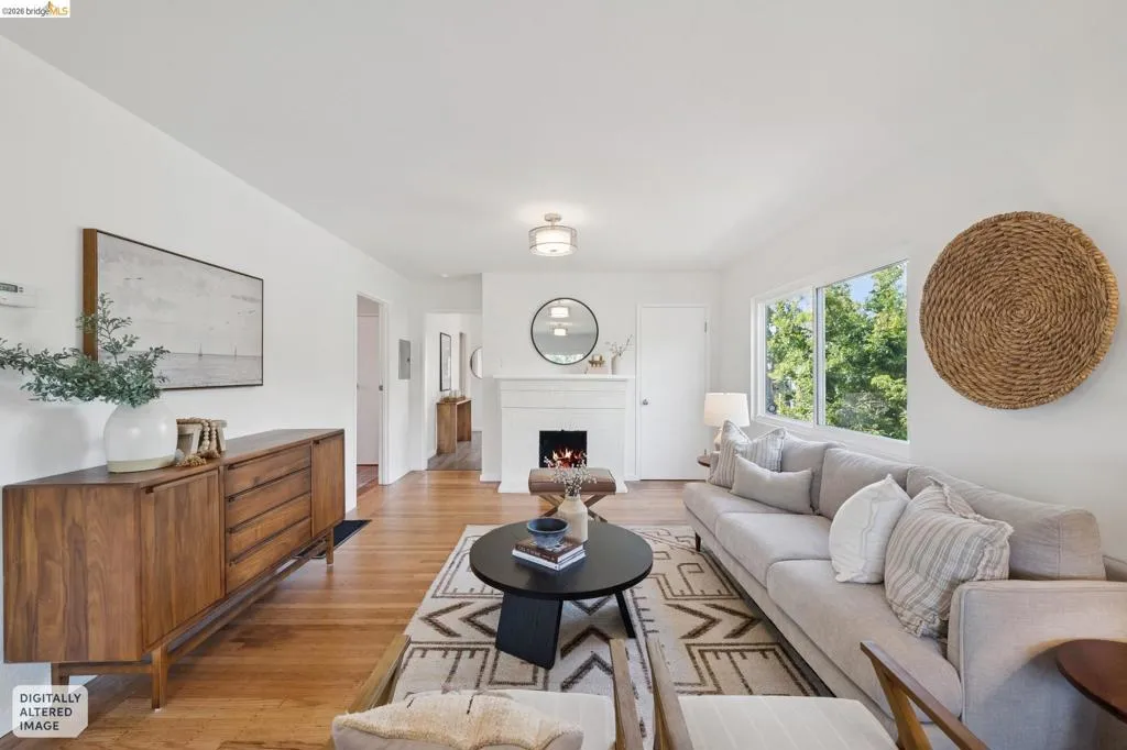 Hardwood flooring throughout and a built-in fireplace with mantle