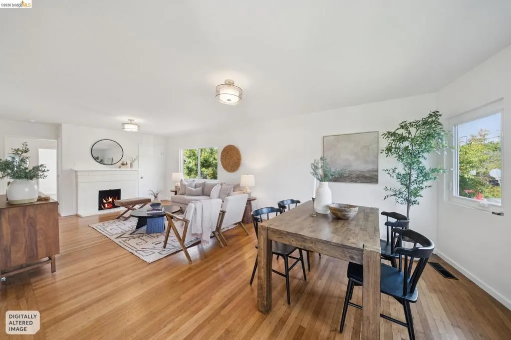 Hardwood flooring throughout, white painted walls, white trim, and a built-in fireplace