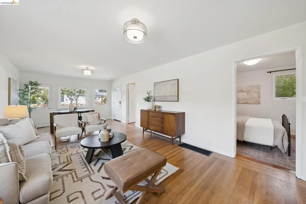 Hardwood flooring throughout, multiple windows, recessed lighting, and a neutral color palette