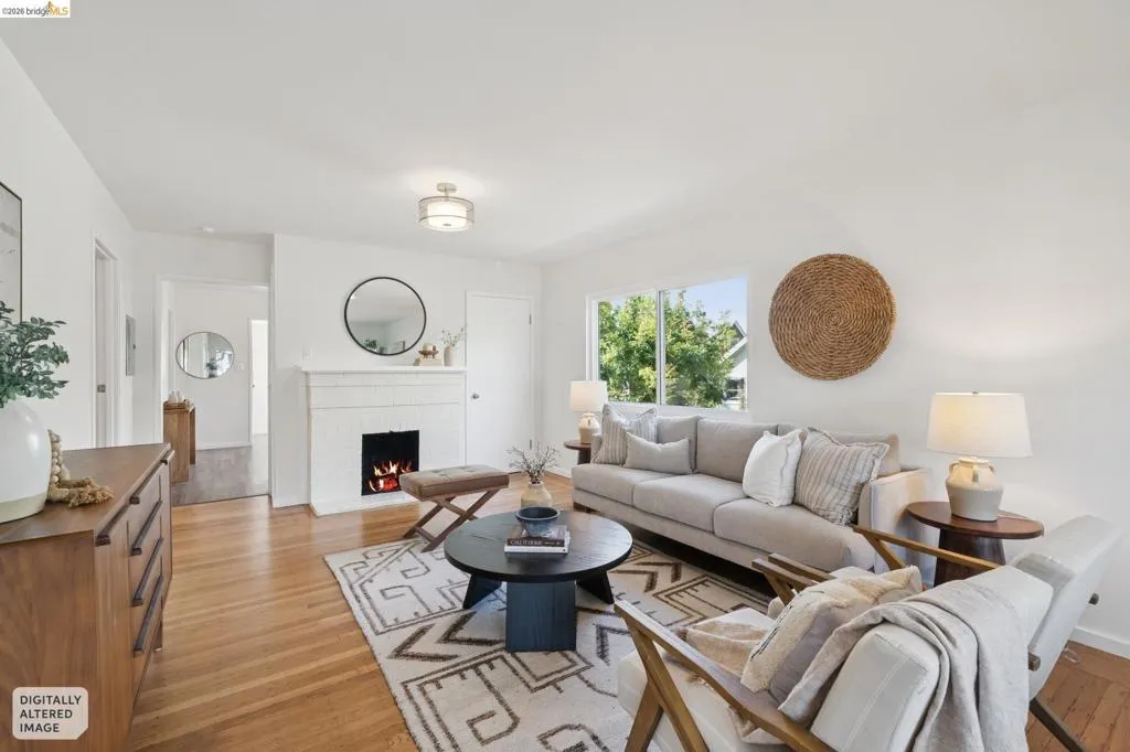 Hardwood flooring, white painted walls, navajo brick fireplace and large dual pane picture windows