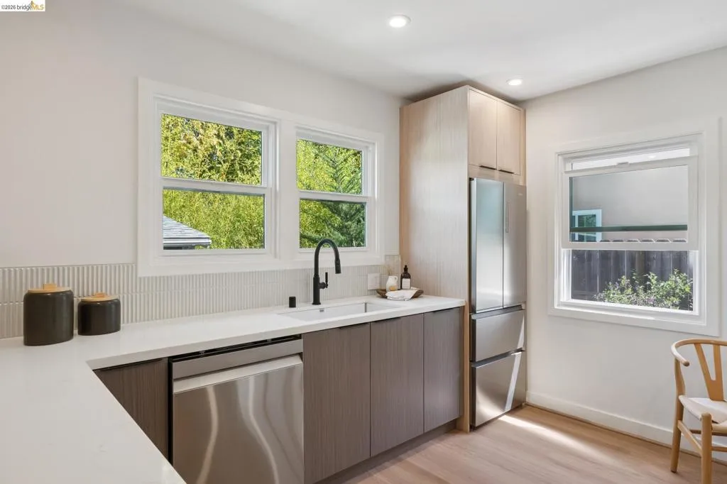 Kitchen featuring stainless steel appliances, wood-finish flooring, recessed lighting, and white countertops