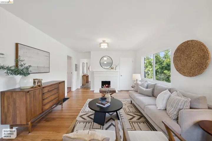 Hardwood flooring throughout and a built-in fireplace with mantle