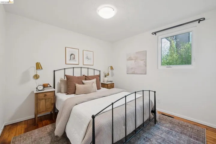 Hardwood flooring, painted white walls, recessed window, and flush-mount ceiling light