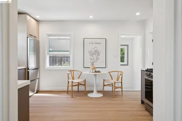 Kitchen area featuring light wood-finish flooring, white walls, and recessed lighting