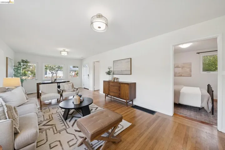Hardwood flooring throughout, multiple windows, recessed lighting, and a neutral color palette