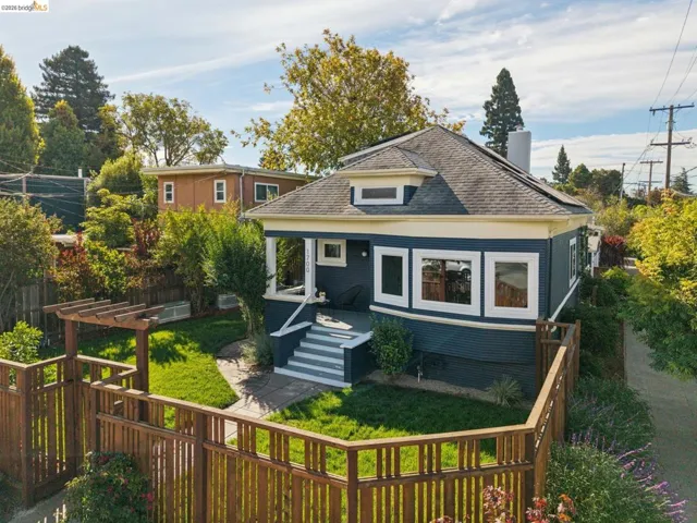 Craftsman-style home with a dark blue exterior, navajo and white trim, featuring a covered porch and front steps