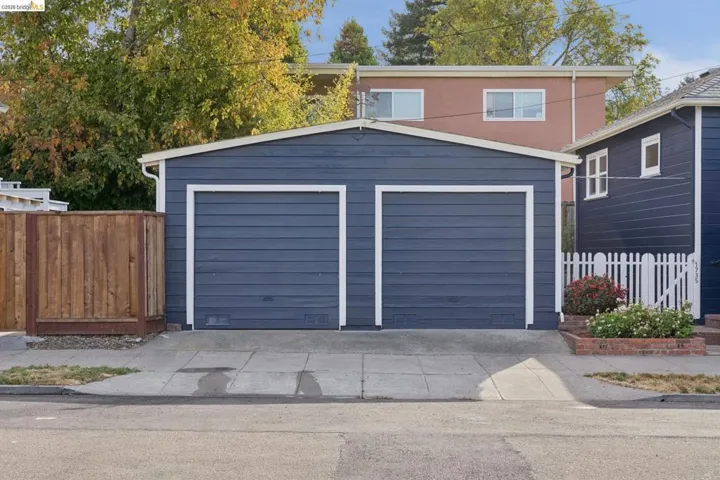 Two-car garage with horizontal siding and white trim