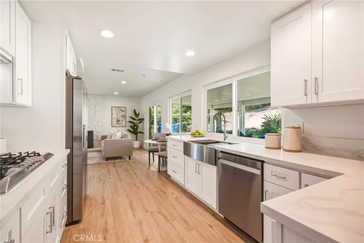 Chef’s kitchen with quartz countertops and backsplash