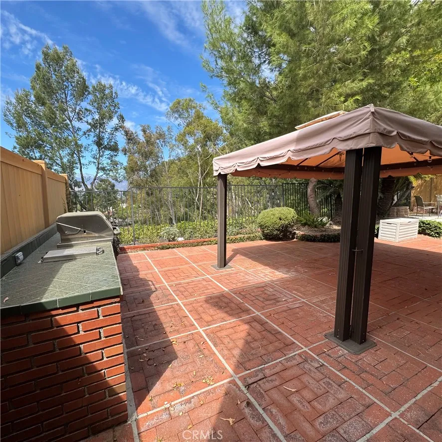 Backyard with a canvas cabana and a built-in BBQ Grill Backyard with a canvas cabana and a built-in BBQ Grill