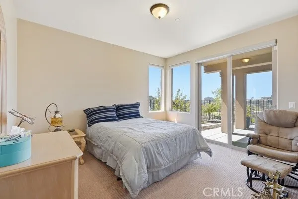 Ground-level bedroom with a private bathroom and direct access to the covered patio.